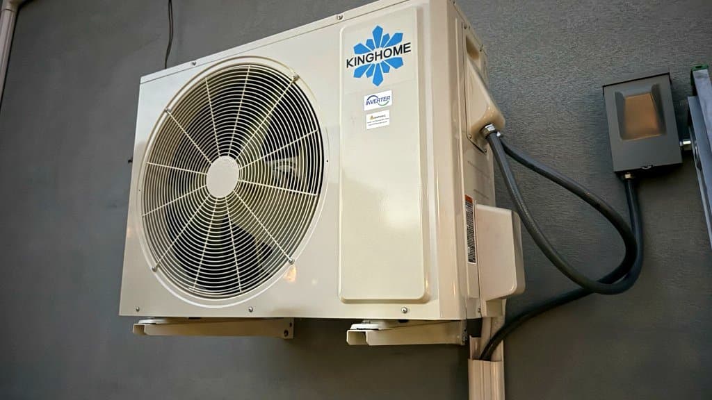 Completed mini-split outdoor unit on a building exterior